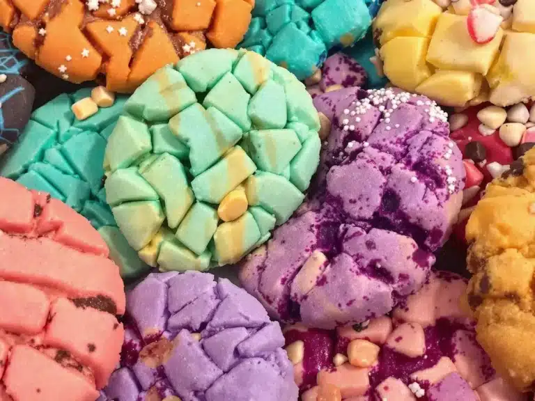 A close-up of vibrant cookies with intricate patterns and colorful toppings.