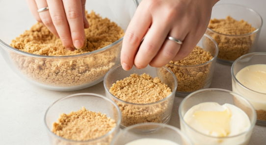 Pressing graham cracker crust into cups for No-Bake Pumpkin Spice Cheesecake Cups