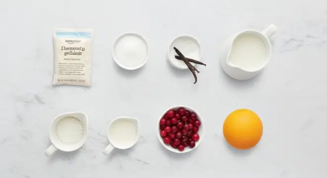 Ingredients for Vanilla Bean Panna Cotta with Cranberry Compote arranged on marble