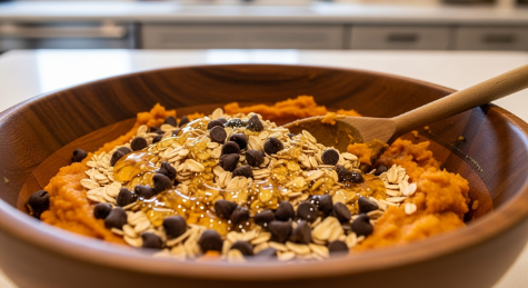 Mixing pumpkin energy bites with oats, honey, and chocolate chips in a modern kitchen