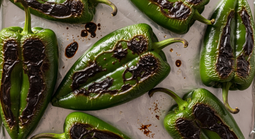 Poblanos charring under the broiler