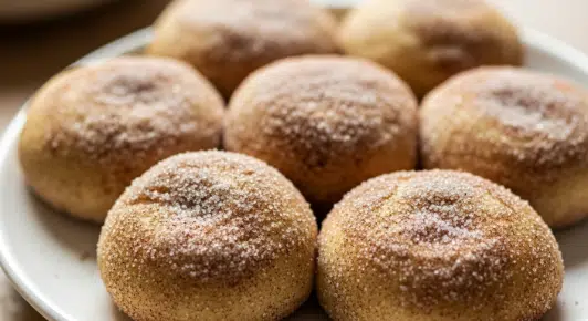 Rolling dough balls in cinnamon sugar for soft cinnamon sugar cookies