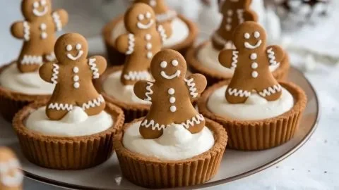 No-Bake Gingerbread Cheesecake Cups topped with whipped cream and gingerbread crumbs