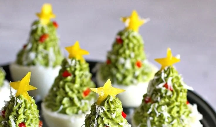 A festive display of deviled egg Christmas trees on a decorative platter.