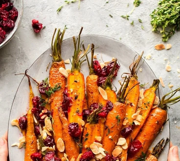 Maple roasted carrots with cranberries served in a bowl, a delicious side dish.
