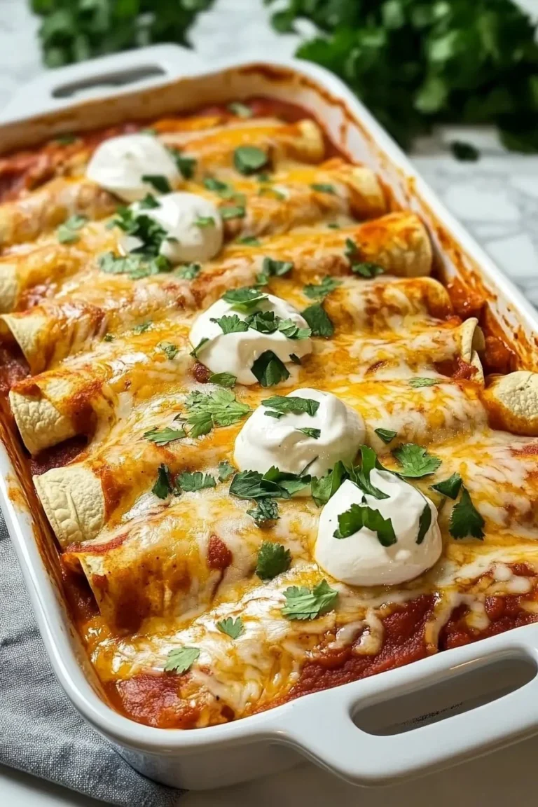 Plate of quick and easy chicken enchiladas topped with fresh cilantro and cheese