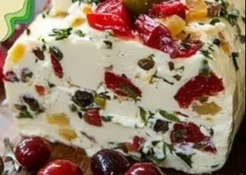 Festive holiday antipasto cream cheese log served on a platter