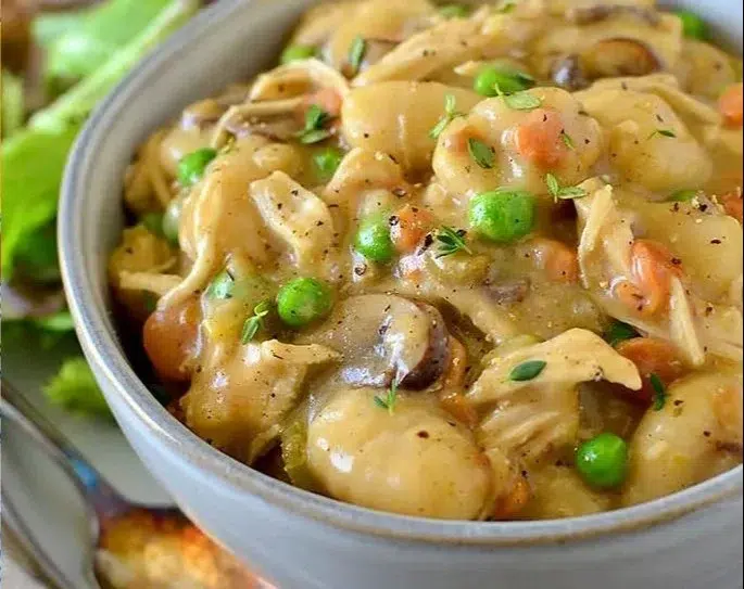 One Pot Gnocchi Chicken Pot Pie served in a rustic dish with vegetables and herbs.