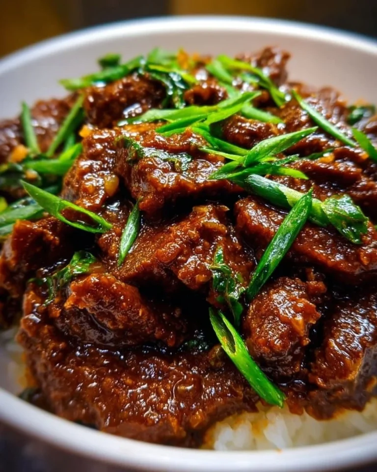 Delicious Slow Cooker Mongolian Beef served with vegetables over rice.