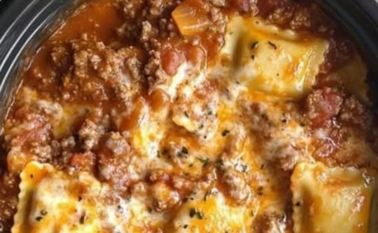 Delicious Crockpot Ravioli Lasagna ready to serve, showcasing layers of ravioli and cheese.